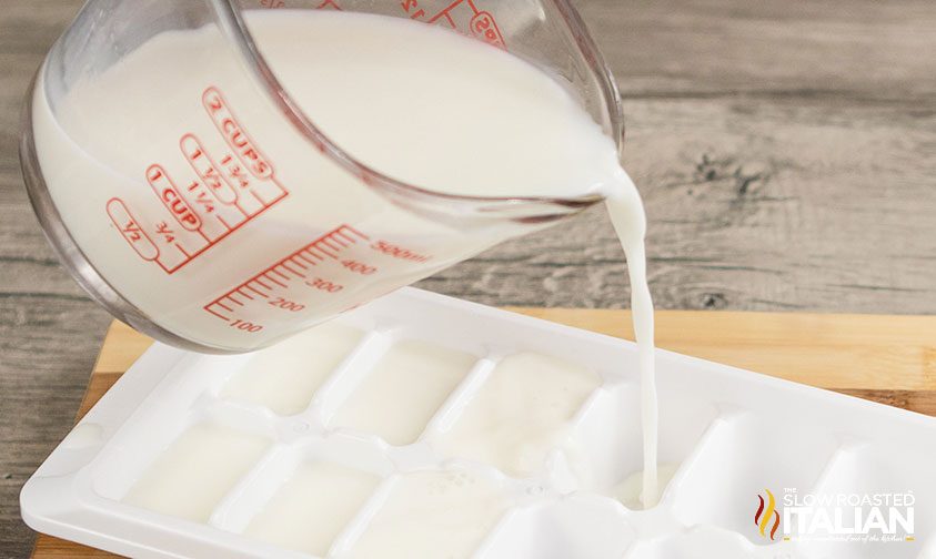 pouring milk in ice cube tray
