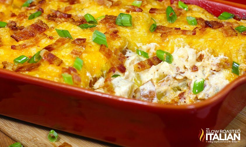 cheesy potato casserole in red baking dish