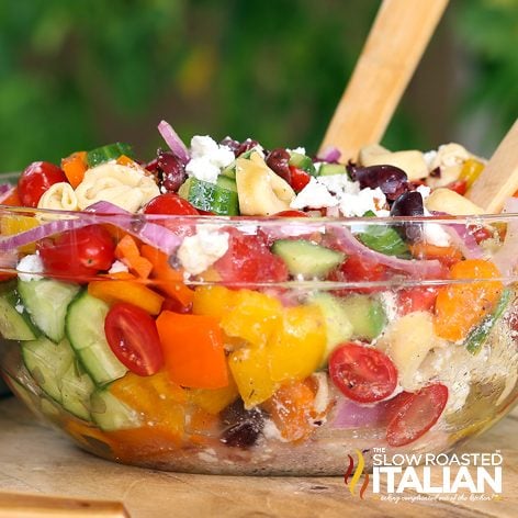 greek tortellini salad in large glass serving bowl