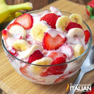 strawberry banana cheesecake salad in glass bowl