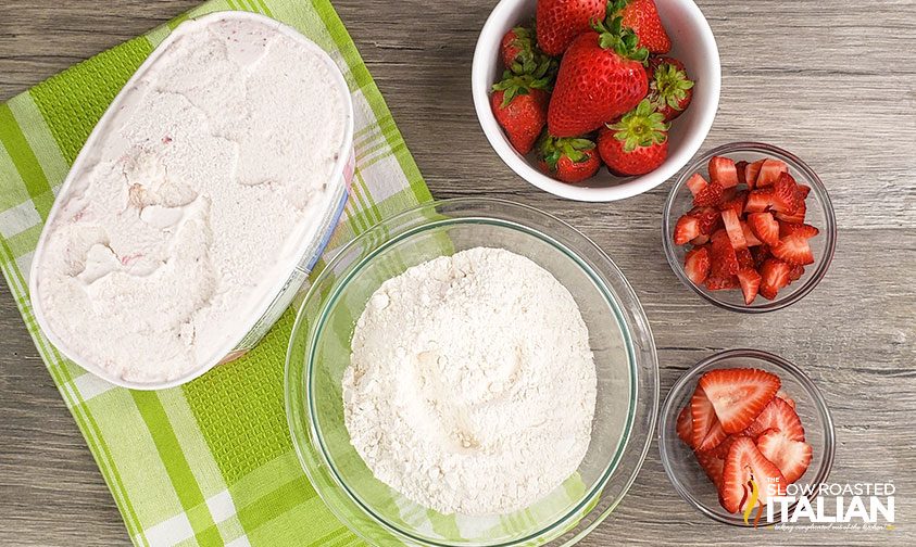 overhead: bowls of flour, melted ice cream and strawberries