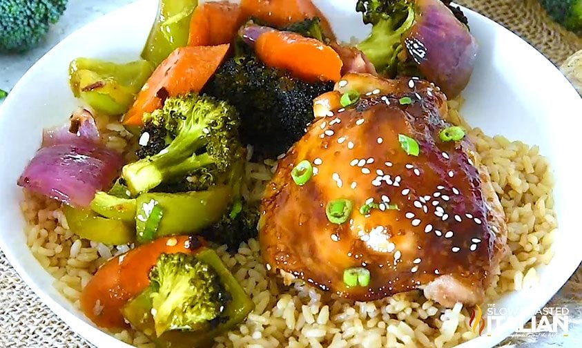teriyaki chicken thighs, vegetables, and rice in shallow bowl