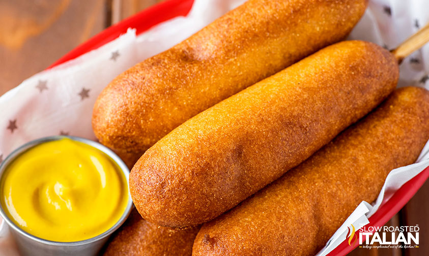 disney corn dogs in basket with mustard