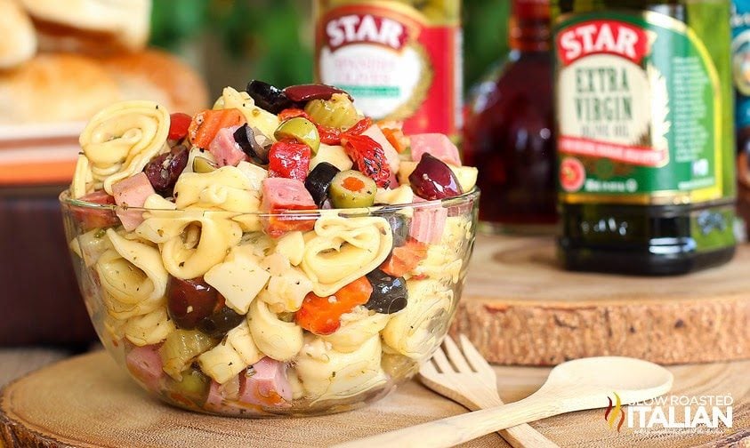 muffaletta pasta salad in glass serving bowl