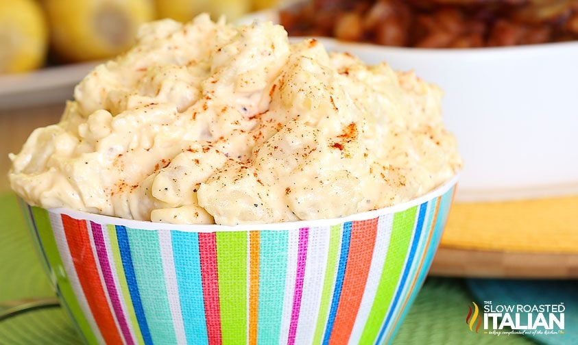 southern potato salad in striped bowl