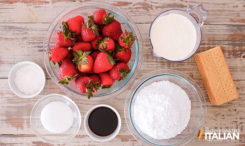 overhead: bowl of fresh strawberries and other icebox cake recipe ingredients