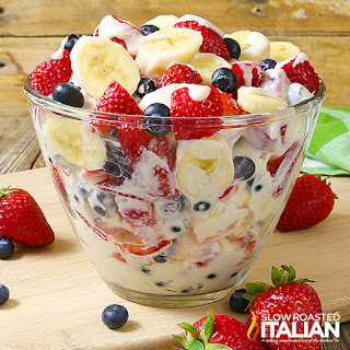 red white and blue cheesecake salad in glass serving bowl