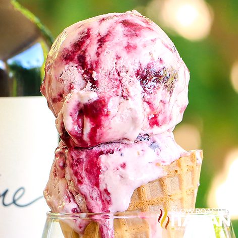 Triple Berry Sangria Ice Cream overflowing in an ice cream cone