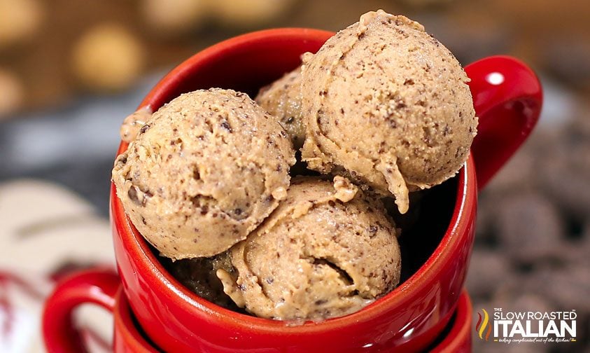 small scoops of chocolate peanut butter ice cream piled into a red mug