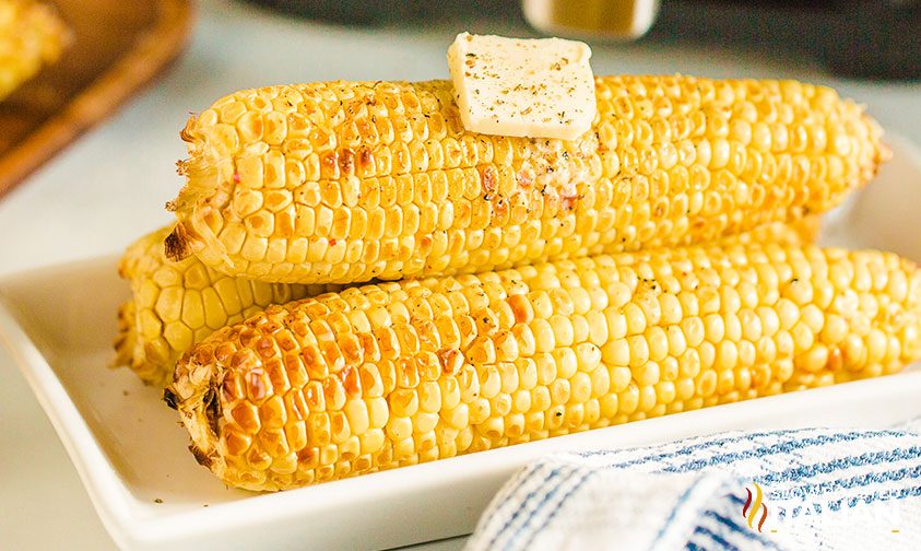 air fryer corn on the cob with a pat of butter