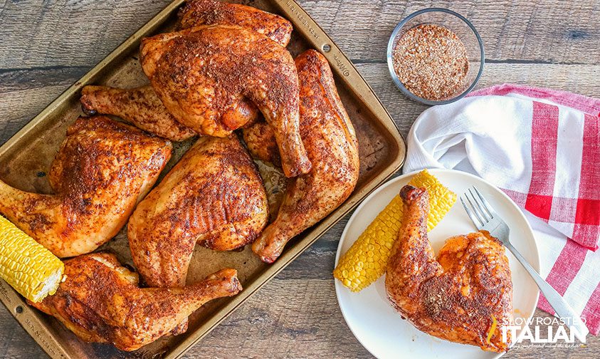 overhead of smoked chicken quarters on a baking sheet