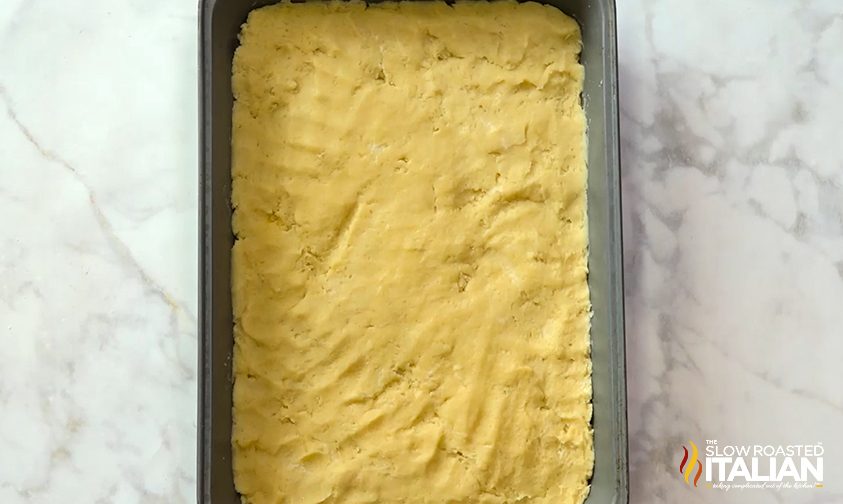 pecan pie dough pressed in bottom of rectangle pan