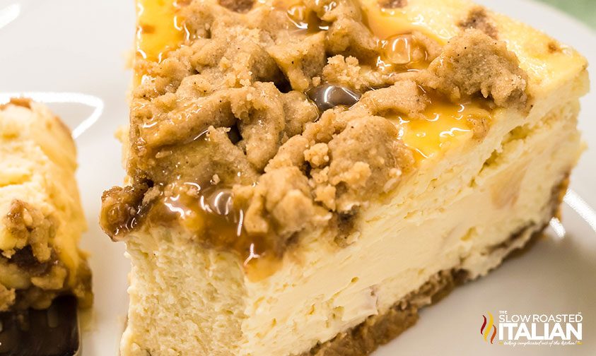 caramel sauce drizzled over slice of apple cheesecake.