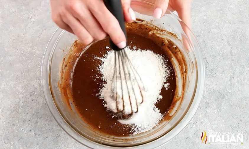 adding flour to brownie batter