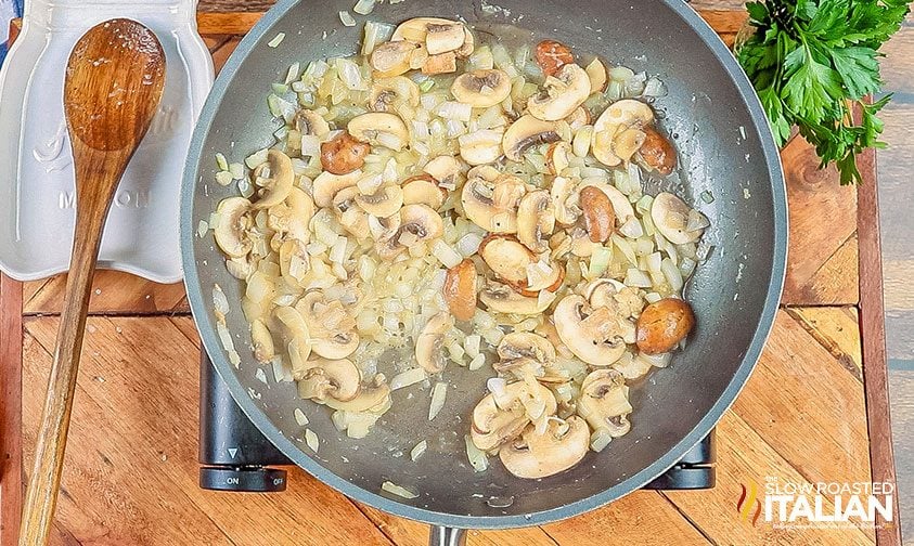 onions and mushrooms cooking in pan