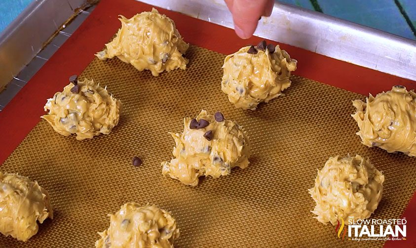 avalanche cookie dough balls sitting on silicone baking mat