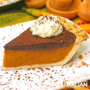 slice of pumpkin pie with chocolate ganache and a dollop of whipped cream