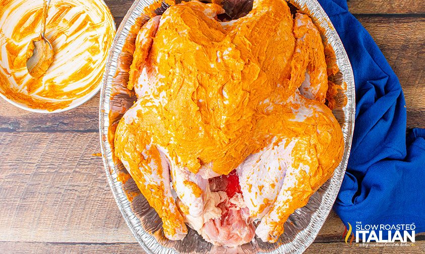 seasoned butter spread on turkey