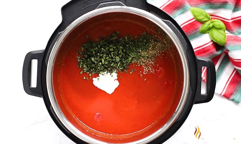 Add spices and cream to tomato soup