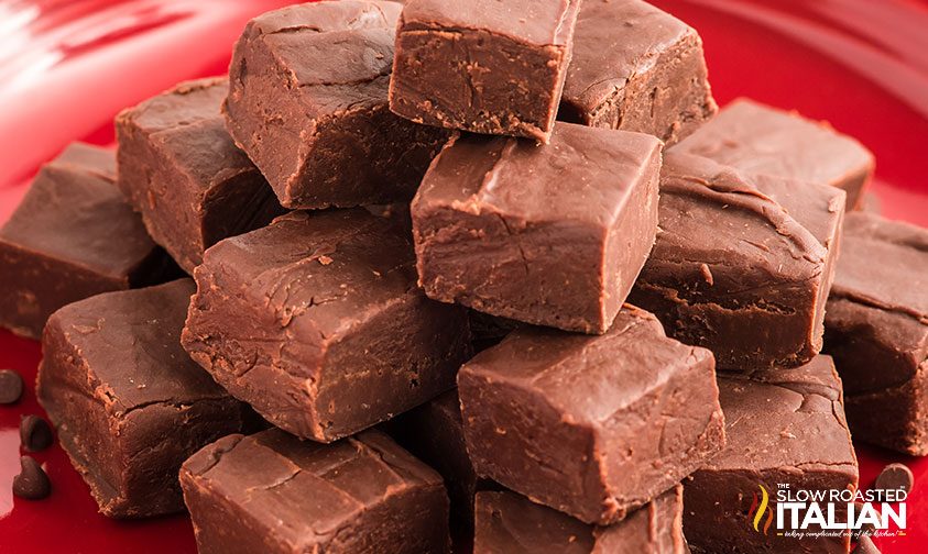 fudge squares stacked on red plate