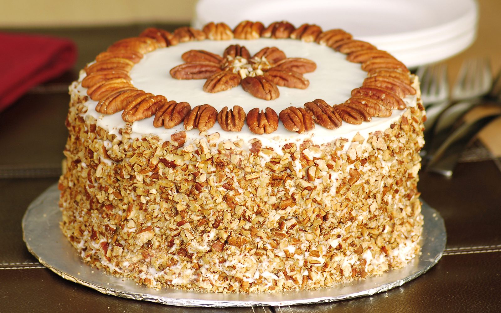 Best Ever Carrot Cake with Toasted Pecans on a cake board