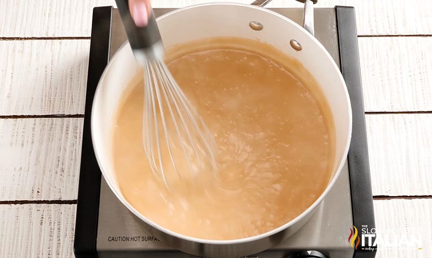 mixing the gravy with a whisk