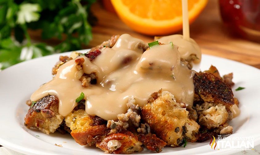 pouring gravy on stuffing