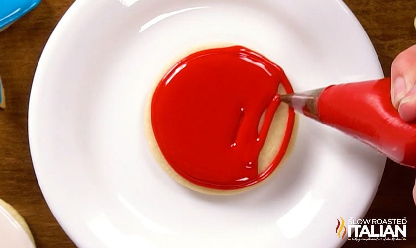 half iced cookie on white plate
