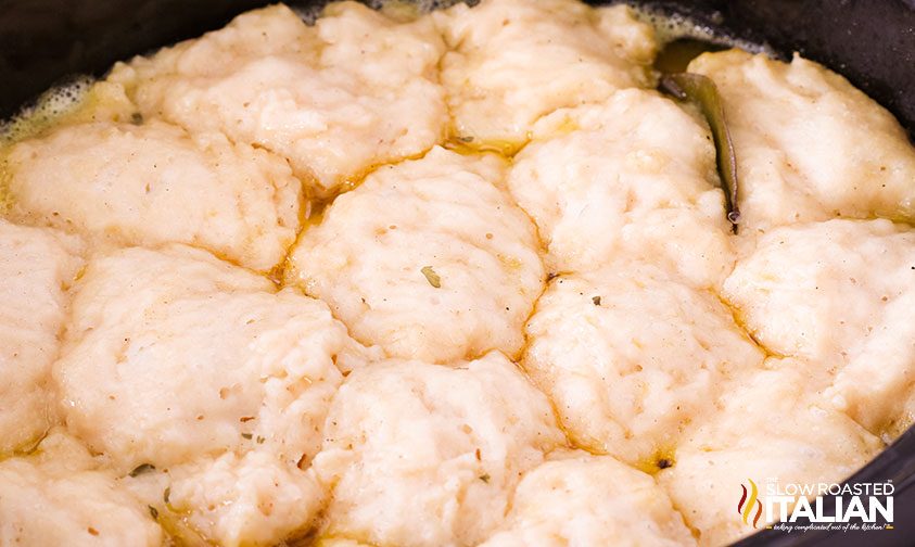 close up of dumplings cooking in soup