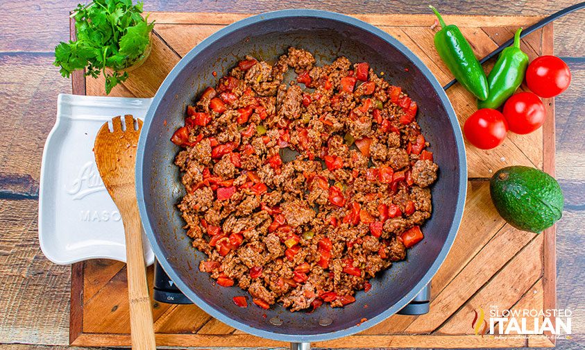 hamburger meat and tomatoes in pan