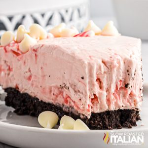 slice of pink cheesecake on chocolate cookie crust