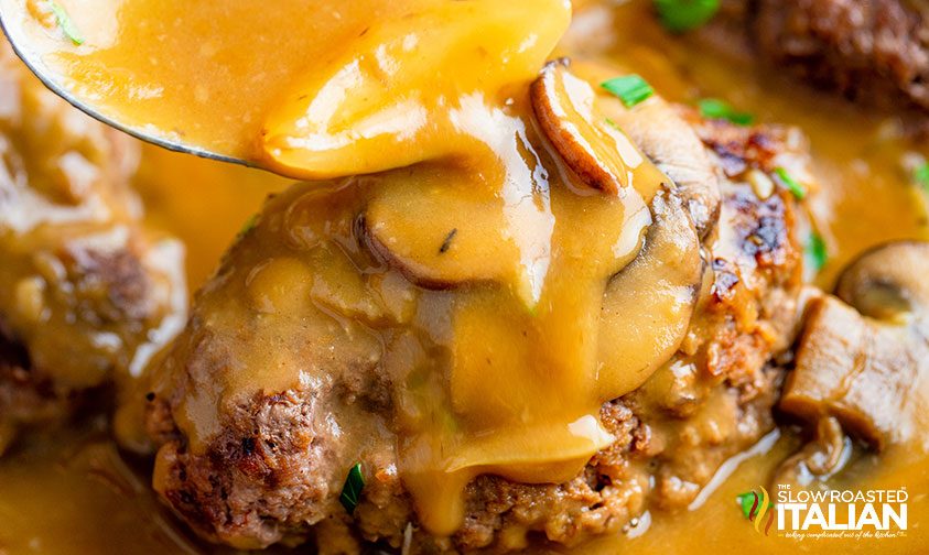 ladling gravy over salisbury steak