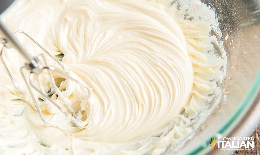 sugar cookie frosting mixed and in glass bowl with whisk
