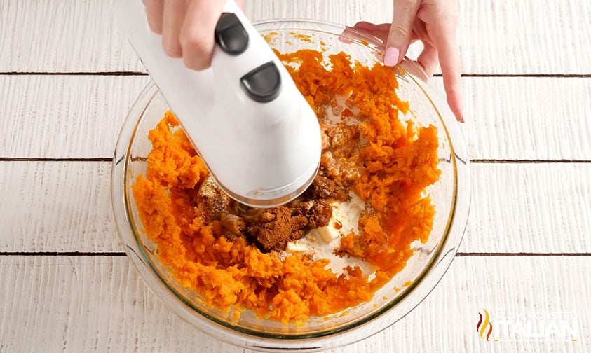 mixing mashed sweet potatoes with brown sugar