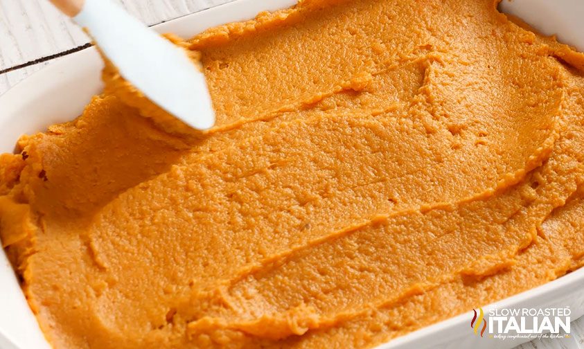 smoothing sweet potatoes in casserole dish