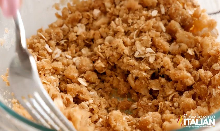 mixing streusel topping for sweet potato casserole with marshmallows