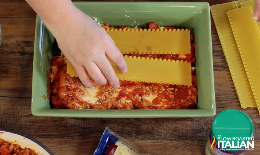 continuing to assemble lasagna in square pan