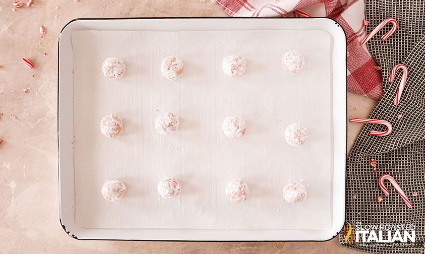 sugar crinkle cookie dough balls arranged on parchment paper