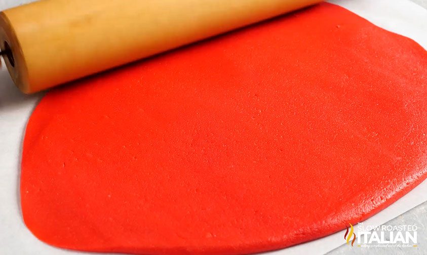 close up: rolling red cookie dough