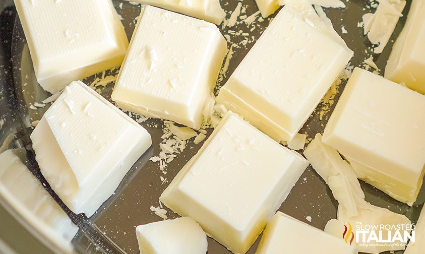 vanilla almond bark chunks melting in pan