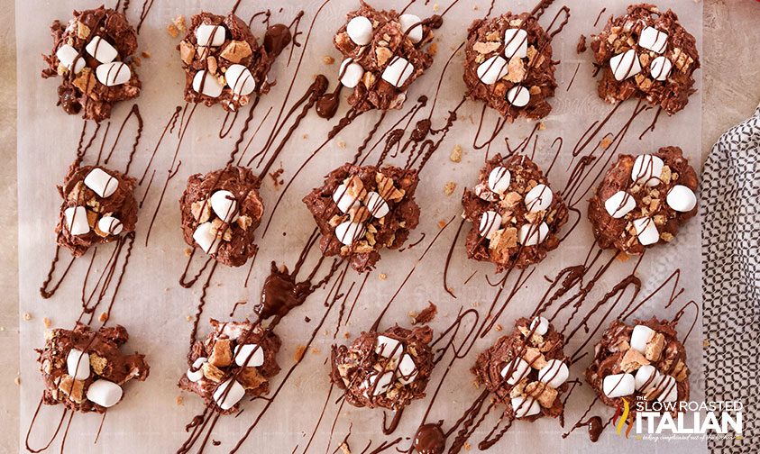 crockpot candy balls on parchment with chocolate drizzle