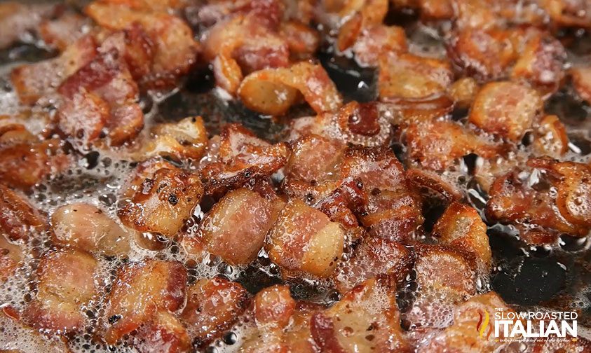 closeup: crispy bacon cooking in skillet