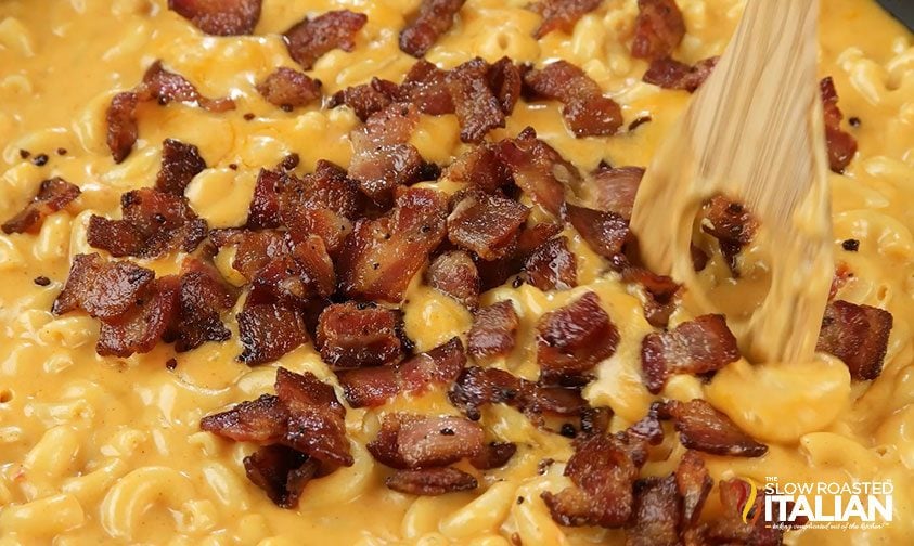 stirring bacon into bourbon mac and cheese