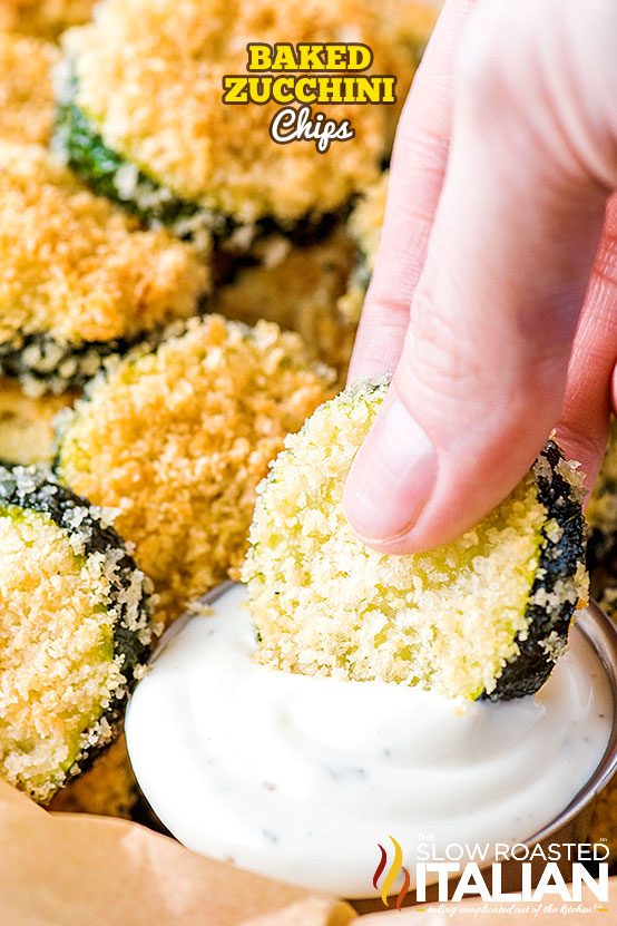 dipping baked zucchini chips into creamy ranch dip