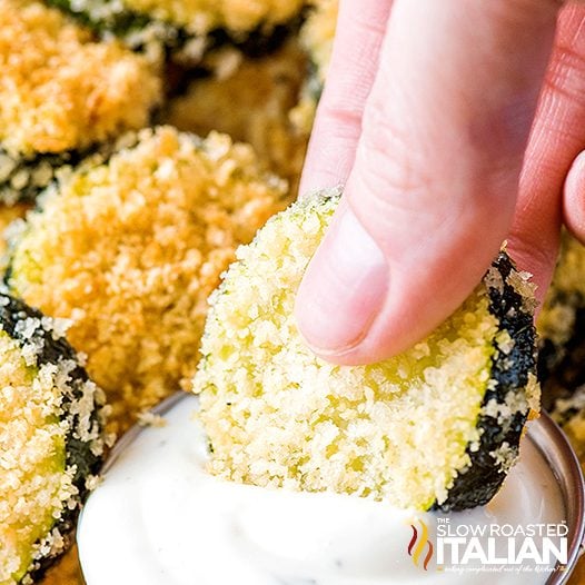 dunking breaded zucchini in ranch dip