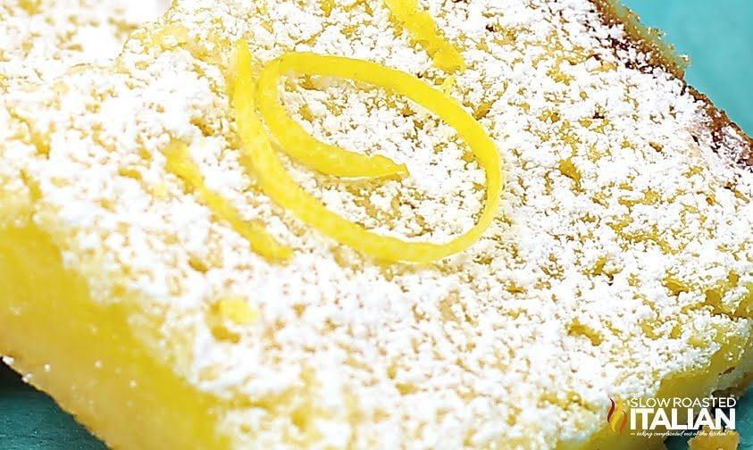close up photo of a lemon dessert with powdered sugar on top