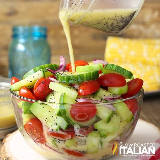 dressing drizzled over cucumber tomato salad