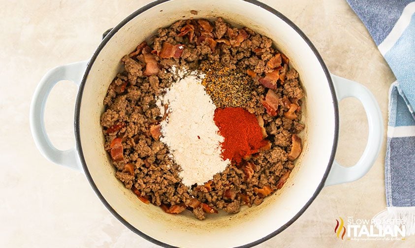 Pot full of ground beef and seasoning