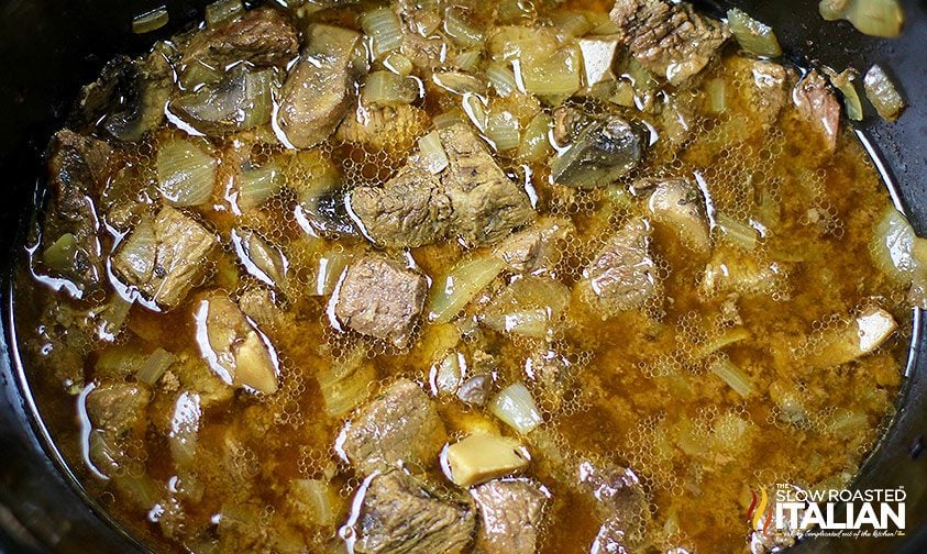 close up photo of slow cooker stroganoff cooking in a crock pot