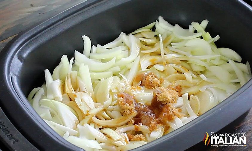 Onions and seasonings in the crock pot